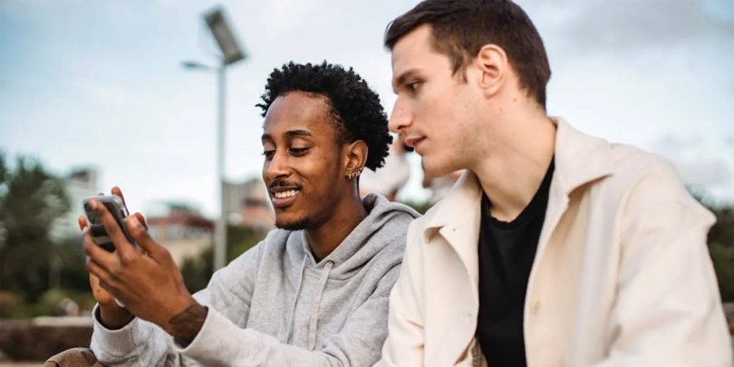 Man showing his friend his cellphone