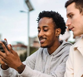 men looking at branded surveys on phone